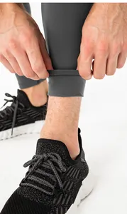 Close-up of gray thermal leggings hem with detail on high-elastic fabric and stitching