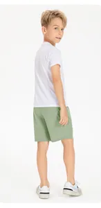 Full rear view of breathable quick-dry green athletic shorts for boys' sports wear