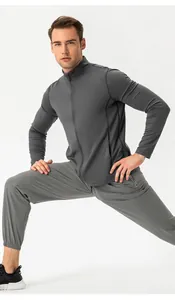 Close-up of men's slim fit grey athletic tracksuit in a stretching pose