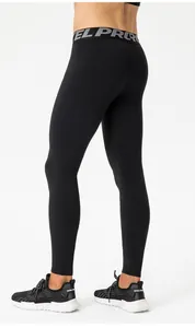 Close-up of men's black compression leggings featuring EL PRO elastic waistband