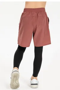 Rückansicht der atmungsaktiven 2-in-1-Sporthose für Jungen mit roten Shorts und Leggings
