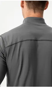 Macro view of gray men's athletic top showing back seam detail and thermal fabric texture.