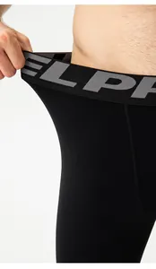 Close-up detail showing the high elastic waistband of men's black compression leggings