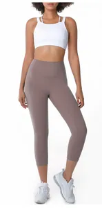 Full view of high-waisted mocha yoga capri leggings on a model for athletic workout