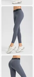 Close-up detail of grey high-waisted yoga pants with side pockets and elastic band.