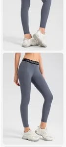 Close-up of high-waist grey yoga leggings with side pocket and 'UPGRADE' elastic waistband.