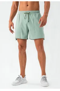 Close-up detail of men's quick-dry sage green athletic shorts with drawstring.