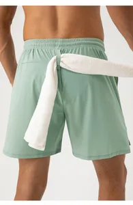 Back view of mint green sports shorts featuring a functional towel loop on waistband