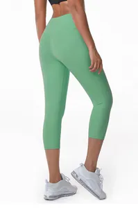 Back view of women's high-waisted green yoga capri leggings showing slim fit design