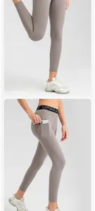 Detailed view of grey high-waist yoga leggings with a convenient side phone pocket.