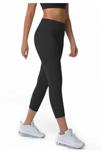 Side view detail of women's black high-waisted cropped yoga pants in action.
