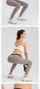Detail view of high-elastic grey yoga leggings showing fit during squatting exercise
