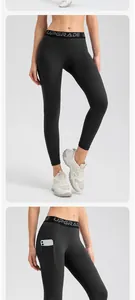 Detail of black high-waist yoga leggings featuring a functional side phone pocket