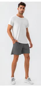 Professional full-length shot of men's loose grey athletic shorts for fitness training
