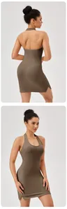 Close-up of olive green ribbed halter yoga dress with open back and side slit detail.