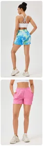 Detail view of high-waisted textured sports shorts in tie-dye and pink colors
