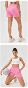 Pink high-waisted textured sports shorts for women shown in back and kneeling front views