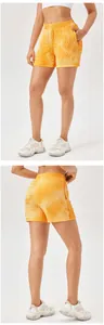 Detail of orange textured high-waisted athletic shorts showing front and back views