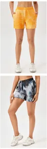 Front and side views of women's textured tie-dye high-waist sports shorts in two colors