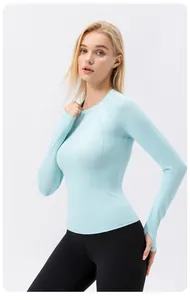 Close-up of slim-fit light blue long-sleeved yoga top showing thumb holes and fabric detail.