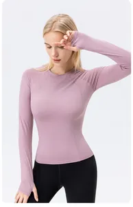 Slim fit lavender long-sleeve yoga top with breathable thumb-hole design for women.