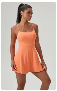 Full view of a breathable orange athletic tennis dress with slim straps on a model
