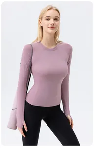 Detailed view of women's tight-fitting long-sleeve sun protection yoga top in mauve color