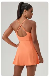 Back view of a vibrant orange athletic tennis dress featuring stylish criss-cross straps.