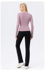 Back view of a breathable purple long-sleeve sun protection yoga top for women