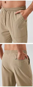 Close-up of men's quick-dry sports pants showing front and zippered back pockets