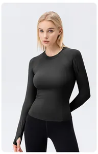 Slim fit black long sleeve yoga top with thumb holes for women’s athletic wear.