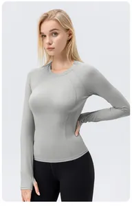 Detailed front view of women's long-sleeved athletic yoga shirt in grey for gym workout