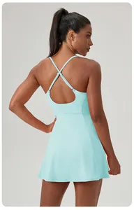 Detailed back view of a light blue athletic tennis dress featuring cross-strap design