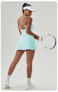 Detail showing light blue backless cross-strap tennis dress on an athletic model