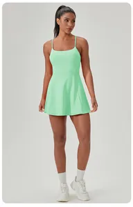 Front view of a mint green quick-dry tennis dress with built-in chest pads on model