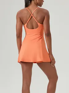 Back view of orange tennis dress with cross-straps and built-in bra