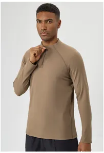 Detail of a men's half-zip athletic long sleeve shirt in camel brown for outdoor sports