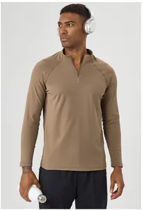 Close-up detail of brown men's half-zip thermal long sleeve shirt for outdoor fitness