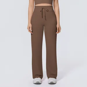 Full frontal view of loose brown high-waisted wide-leg yoga pants with drawstring waist