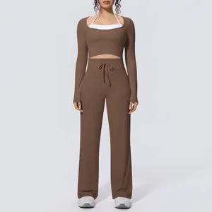 Front view of a brown long-sleeved cropped yoga top and matching wide-leg trousers set
