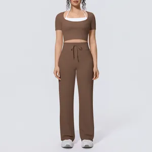 Women's brown two-piece yoga set with short sleeve crop top and wide-leg sports pants