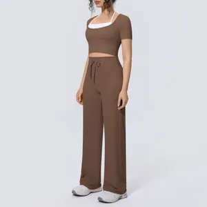 Detailed view of brown two-piece yoga set with short sleeve top and wide leg pants