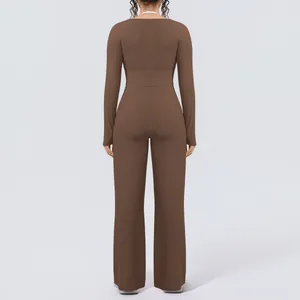 Back view of brown long-sleeved cropped yoga top and wide-leg Pilates pants set.