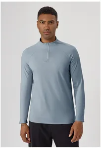 Detail of men's half-zip athletic long sleeve shirt in stylish greyish blue color
