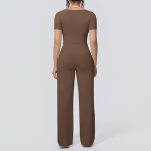 Back view of a brown two-piece yoga set with short-sleeve top and wide-leg pants
