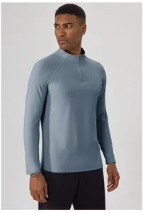Close-up view of a men's blue-grey half-zip thermal athletic long sleeve shirt on model