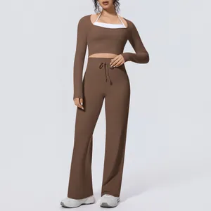 Full view of women's brown yoga set with long sleeve crop top and wide leg pants