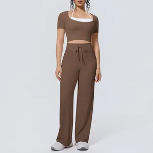Front view of a brown yoga set featuring a short-sleeve crop top and wide-leg trousers