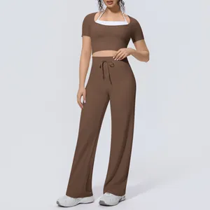 Detail view of brown workout set featuring halter-neck crop top and wide-leg yoga pants