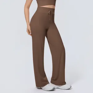 Detailed view of brown wide-leg yoga pants featuring a high waist and adjustable drawstring
